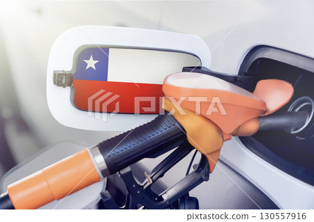 The flag of Chile on the hatch of the gas tank of a car at a gas station in close-up. High or low prices at Chilean gas stations. Problems with the fuel quality of gasoline and diesel fuels and their 130557916