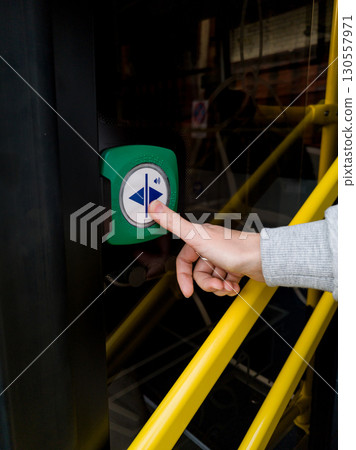 woman presses the button to open doors woman presses the button to open doors 130557971