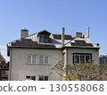 Brick House With Solar Panels on Sunny Day 130558068