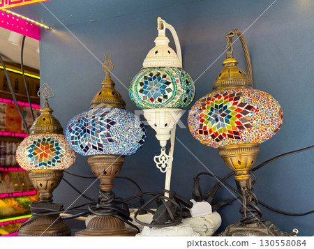 Colorful mosaic lamps with intricate star patterns and vibrant glass design. Cultural heritage, traditional craft, and decorative illumination in lifestyle and interior art. 130558084