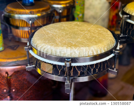 Traditional drum with skin surface and metal structure. Musical culture, rhythm and artistic heritage in performance and sound expression. Traditional drum with skin surface and metal structure. Musical culture, rhythm and artistic heritage in performance and sound expression. 130558087