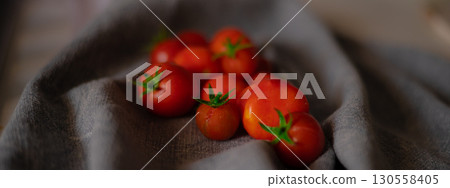 Red tomatoes on grey kitchen towel 130558405