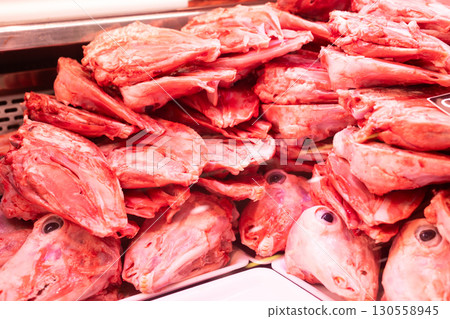 Raw sheep heads displayed in butcher showcase window Raw sheep heads displayed in butcher showcase window 130558945