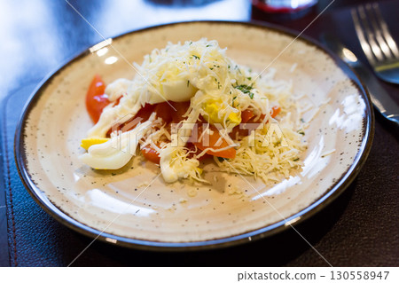plate with a mix of tomatoes, cheese, eggs with french sauce plate with a mix of tomatoes, cheese, eggs with french sauce 130558947