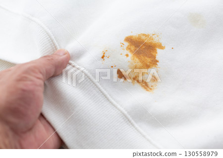 A white sweatshirt stained with food spills 130558979