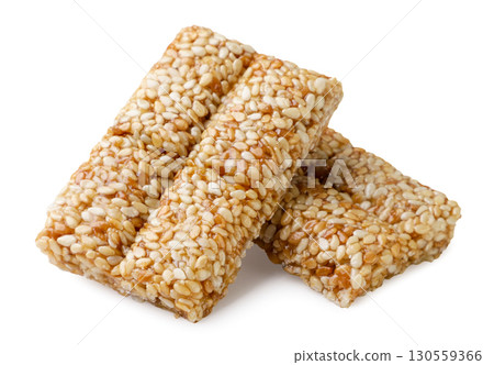 Two pieces of kozinaki with sesame seeds on a white background. Isolated 130559366