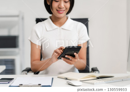 Business woman or financial data analysts working with laptop and calculator show increase market share, growth of profit investment at home office. Business woman or financial data analysts working with laptop and calculator show increase market share, growth of profit investment at home office. 130559933