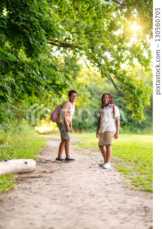 Two teens having a walk in the park after school 130560705