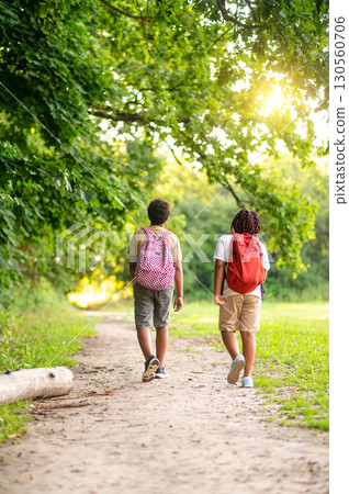 Two teens having a walk in the park after school Two teens having a walk in the park after school 130560706