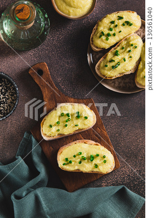 Green zucchini spread on bread sandwich on board on table top and vertical view Green zucchini spread on bread sandwich on board on table top and vertical view 130561040