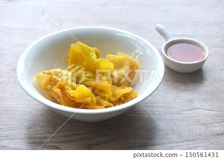 crispy fried dumpling paste stuffed chop pork and shrimp dipping sweet chili sauce on bowl 130561431
