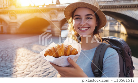 paris woman sunset backpack bridge stands young croissant 130561512