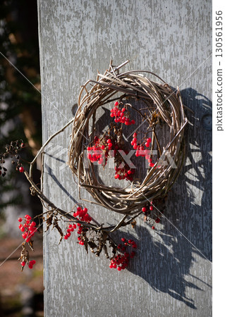Wreath decorated with red nuts 130561956
