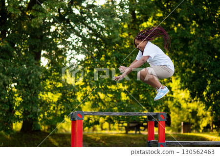 Girl playing at the playground and looking happy and energized 130562463
