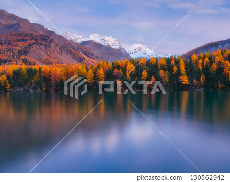 Nature. Mountain lake at dawn. Bright sky and clouds. Reflections on the water surface. 130562942