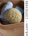 Dermo Aqua soft bath sponge on a wooden background 130563486