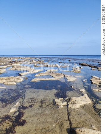 Rocky area stretching out to the ocean horizon 130563934