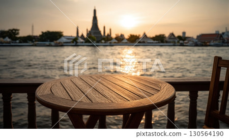 Wooden table balcony view of Wat Arun temple by Chao Phraya River at sunset Bangkok 130564190