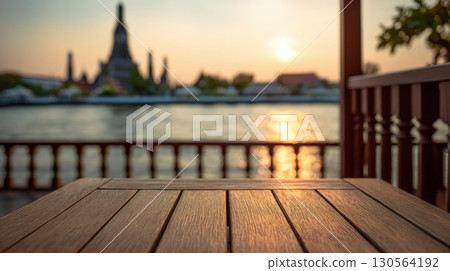 Wooden table balcony view of Wat Arun temple by Chao Phraya River at sunset Bangkok 130564192