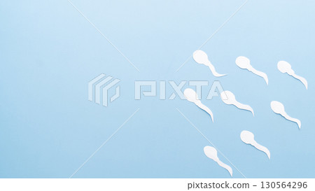 Sperm cells competition on blue background. Concept of fertilization, birth, male reproductive and sperm test. 130564296