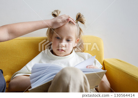 Father checking daughters forehead for fever Father checking daughters forehead for fever 130564414