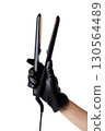 Hand holding professional hair straightener, beauty tool, hair styling concept isolated on transparent background 130564489