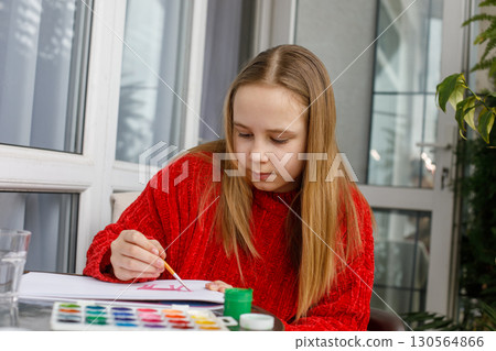 Cheerful kid drawing. Cute child at home 130564866