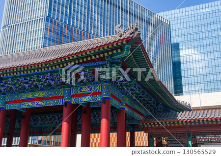 Chinese traditional architecture on a background of a modern skyscrapers in Chinese business center Park Huaming Chinese traditional architecture on a background of a modern skyscrapers in Chinese business center Park Huaming 130565529