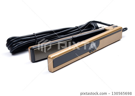 Gold eletronic hair iron straightener on white background Gold eletronic hair iron straightener on white background 130565698