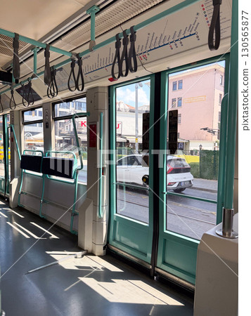 Interior of modern tram with doors and handles. Public transport, travel, and city mobility. Interior of modern tram with doors and handles. Public transport, travel, and city mobility. 130565877
