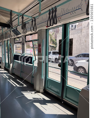 Interior of modern tram with doors and handles. Public transport, travel, and city mobility. Interior of modern tram with doors and handles. Public transport, travel, and city mobility. 130565881