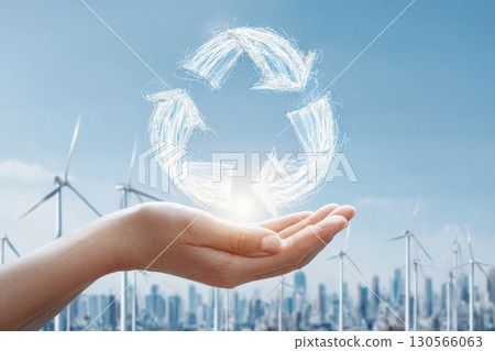 Hands Holding Glowing Circular Economy Icon Over Wind Turbines and City Skyline Hands Holding Glowing Circular Economy Icon Over Wind Turbines and City Skyline 130566063