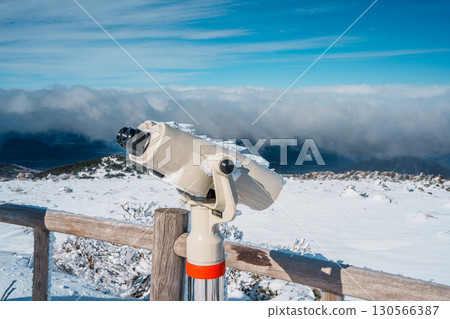 Frosted binocular viewer overlooking winter landscape on Hallasan, Jeju 130566387