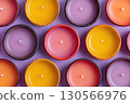 Colorful Wax Candles in Clay Holders on Purple Background 130566976