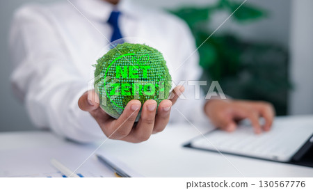 Business Person Holding Green Moss Globe with NET ZERO Text for Sustainability and Climate Action Business Person Holding Green Moss Globe with NET ZERO Text for Sustainability and Climate Action 130567776