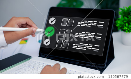 Hand Using Stylus on Tablet Digital Checklist Interface for Productivity and Workflow Management 130567779