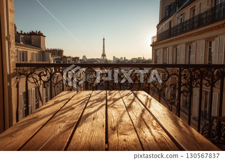 Empty wooden table on balcony with Eiffel Tower view at golden hour Paris skyline Empty wooden table on balcony with Eiffel Tower view at golden hour Paris skyline 130567837