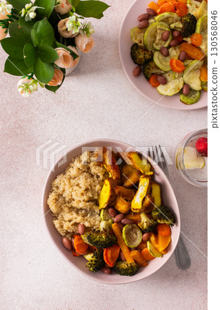 A nutritious breakfast spread includes quinoa, baked sweet potatoes, carrots, zucchini, broccoli, beans, tender chicken breast, and a vibrant fresh salad, ready for enjoyment A nutritious breakfast spread includes quinoa, baked sweet potatoes, carrots, zucchini, broccoli, beans, tender chicken breast, and a vibrant fresh salad, ready for enjoyment 130568046