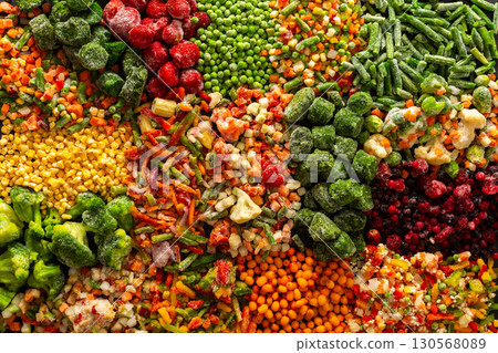A vivid display of frozen fruits and vegetables in a colorful arrangement, illustrating the process of preserving healthy, seasonal produce for winter, promoting a healthy diet 130568089