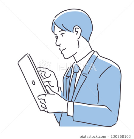A man in a suit looking at a tablet 130568103