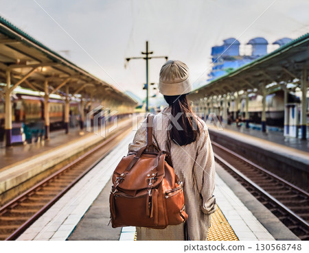 A woman waiting for a train at the station 130568748