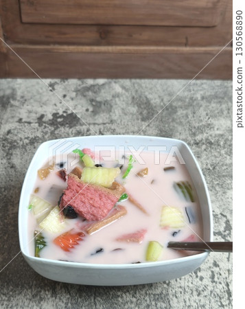 A refreshing bowl of Es Campur, a traditional Indonesian ice mixed fruit dessert. 130568890