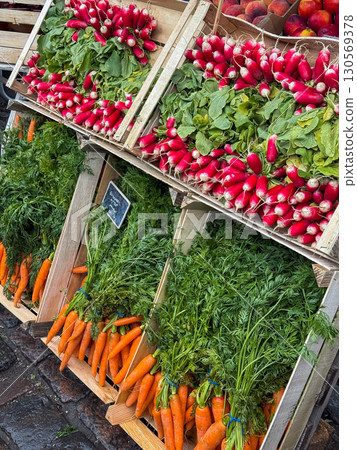 Fresh carrot and radish sold on farmers market of vegetables. Beautiful example of small business organization. Healthy nutrition with local seasonal farm products. Fresh carrot and radish sold on farmers market of vegetables. Beautiful example of small business organization. Healthy nutrition with local seasonal farm products. 130569378