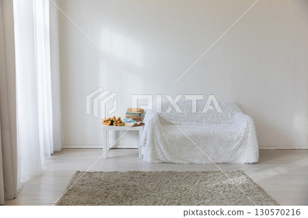 Interior of a room with vases of flowers, gifts and a sofa Interior of a room with vases of flowers, gifts and a sofa 130570216