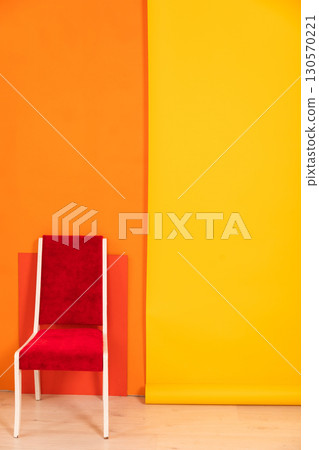 chair in the interior of an empty yellow orange room 130570221