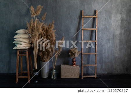 Wicker baskets with dry pampas grass and flowers. Living room hygge, autumn home decor. 130570237