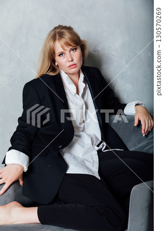 Portrait of a beautiful young woman in a black suit Portrait of a beautiful young woman in a black suit 130570269