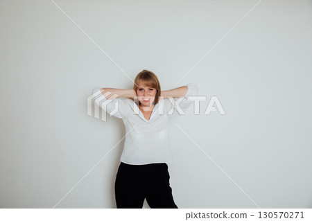 Portrait of a happy woman with closed eyes over gray background 130570271