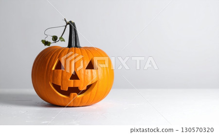 An eerie, carved jack-o'-lantern with a sinister smile glows against a dark background, a classic symbol of the autumn Halloween season An eerie, carved jack-o'-lantern with a sinister smile glows against a dark background, a classic symbol of the autumn Halloween season 130570320