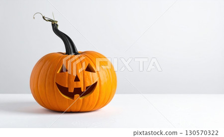 An eerie, carved jack-o'-lantern with a sinister smile glows against a dark background, a classic symbol of the autumn Halloween season An eerie, carved jack-o'-lantern with a sinister smile glows against a dark background, a classic symbol of the autumn Halloween season 130570322